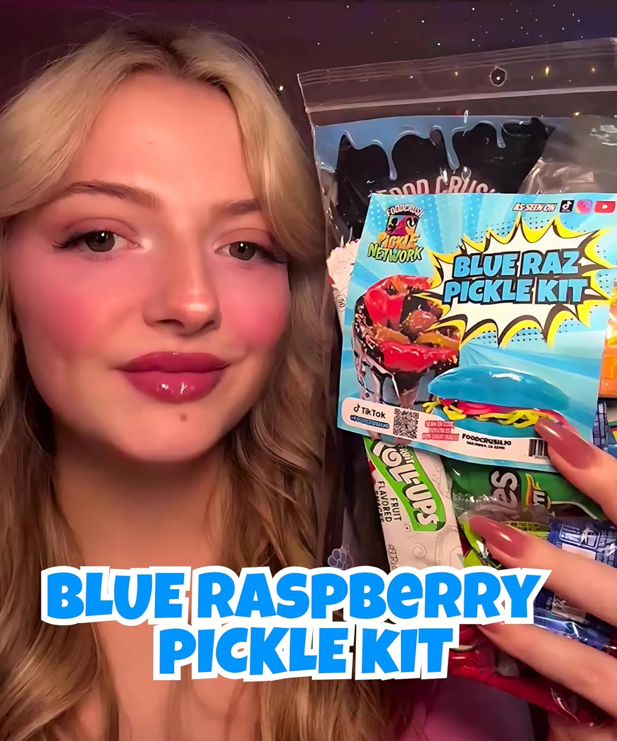 Ashley Dashley from Tiktok holding a Blue Raspberry Pickle Kit with packaging in the background